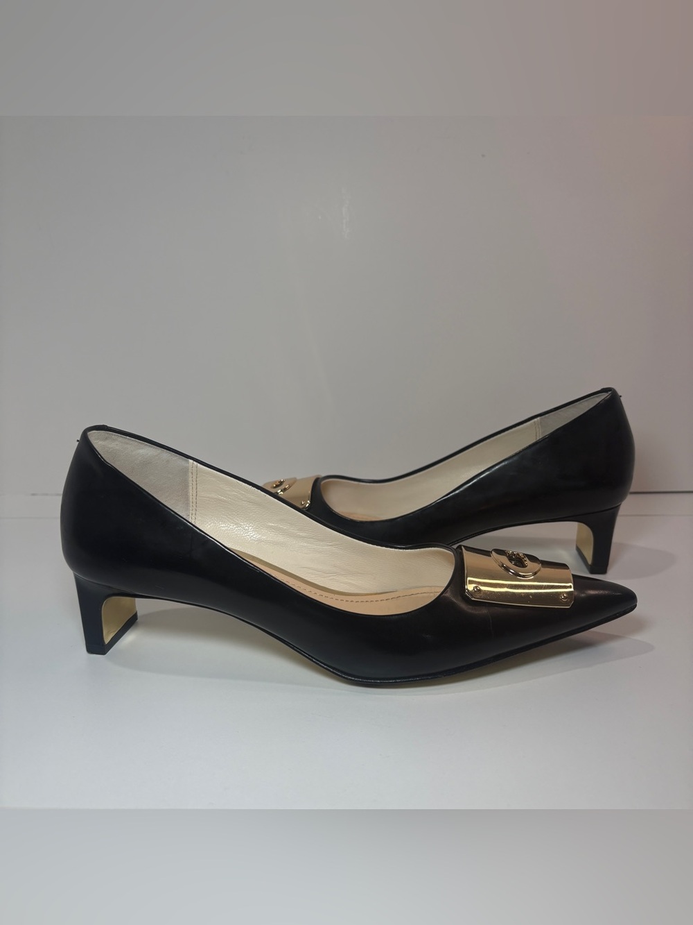 Coach Black Leather Pointed Toe Pumps with Gold Plaque